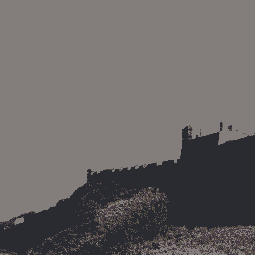 A black-and-white analog photograph of a fortress next to the sea.